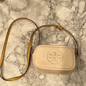 Tory Burch Perry mini bombe bag, cream colored leather with a mustard strap.
